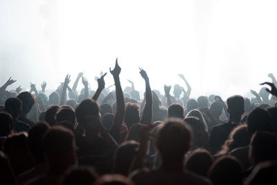 Crowd of people partying at live concert at music festival