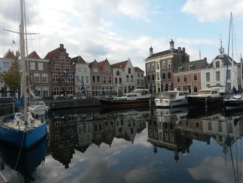 Boats in river with buildings in background