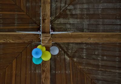 Close-up of multi colored balloons hanging on wood