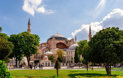 Panoramic view of trees and buildings against sky