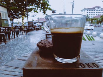 Close-up of coffee on table against building