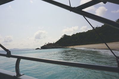 Boat sailing in sea against sky