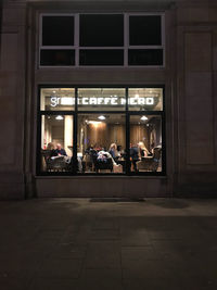 Group of people in illuminated building at night