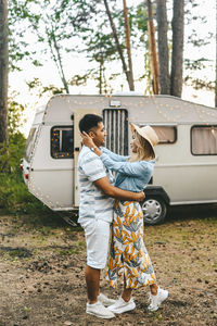 Married asian couple in love travel by camper car on a road trip in nature on their honeymoon