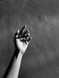 Close-up of human hand on wall