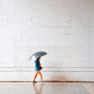 Side view of man walking on footpath