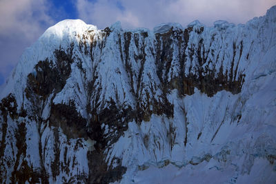 Low angle view of snowcapped mountains against sky 