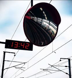 Low angle view of information sign against sky