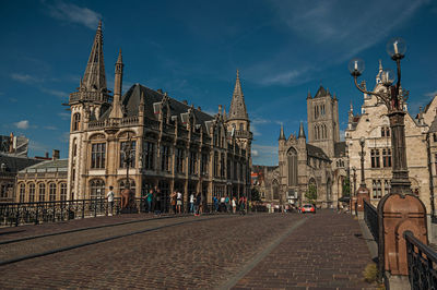 Street amidst buildings against sky in city