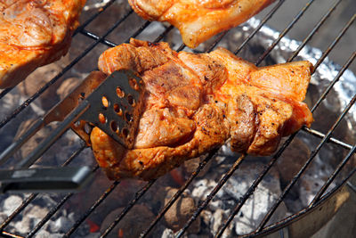 Close-up of meat cooking on barbecue grill