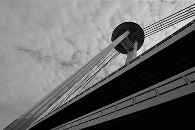 Low angle view of bridge and building against sky