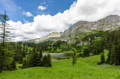 Scenic view of lake and mountains against sky