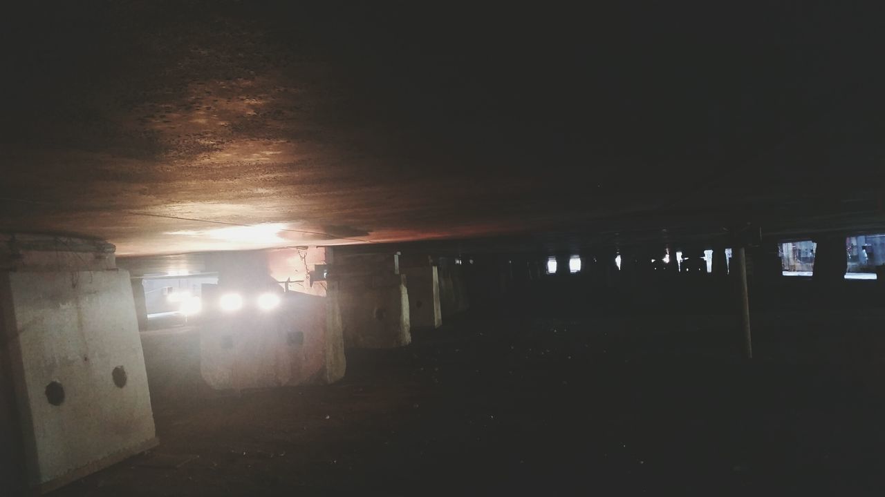 indoors, architecture, built structure, illuminated, corridor, architectural column, ceiling, the way forward, interior, dark, empty, column, lighting equipment, light - natural phenomenon, sunlight, flooring, abandoned, building, wall - building feature, in a row