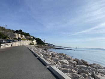 Scenic view of sea by city against sky