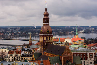 View of cityscape against cloudy sky