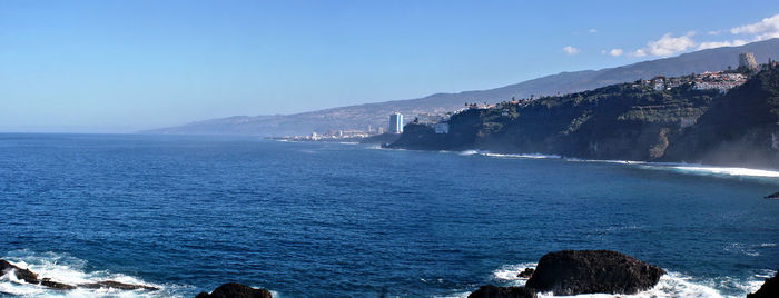 Scenic view of sea against clear blue sky