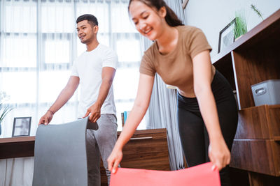 Side view of couple standing at home