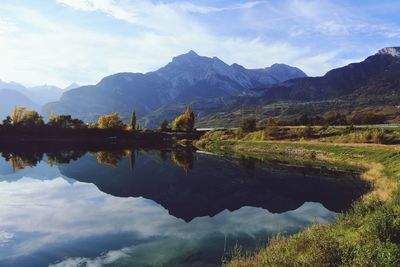 Scenic view of lake and mountains against sky