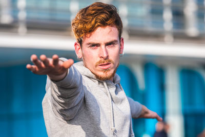 Portrait of young man standing outdoors