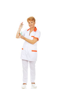 Full length portrait of woman standing against white background