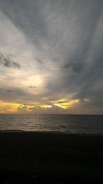 Scenic view of beach against sky during sunset