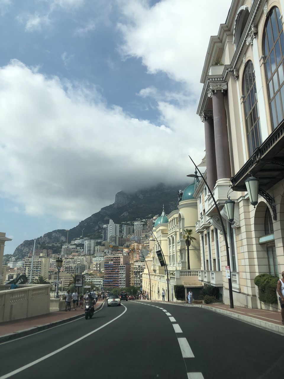 ROAD AMIDST BUILDINGS AGAINST SKY