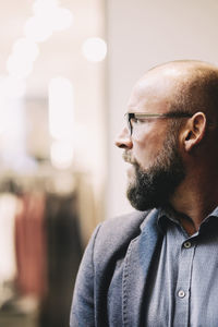 Close-up of thoughtful businessman looking away at office