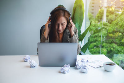 Young woman using laptop on table