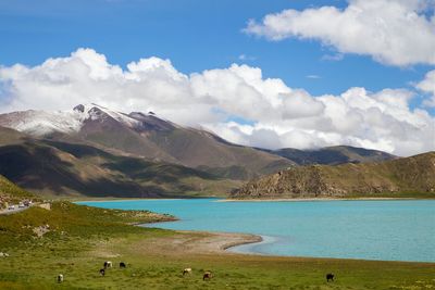 Scenic view of mountains against cloudy sky