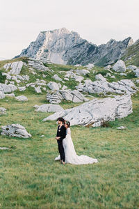 Rear view of woman standing on field