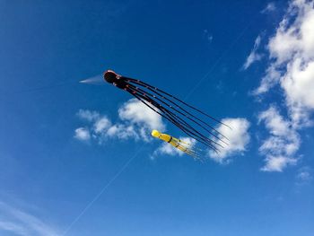 Low angle view of vapor trail against blue sky