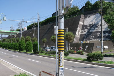 Road by city against sky