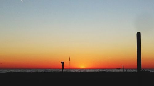 Scenic view of sea against orange sky