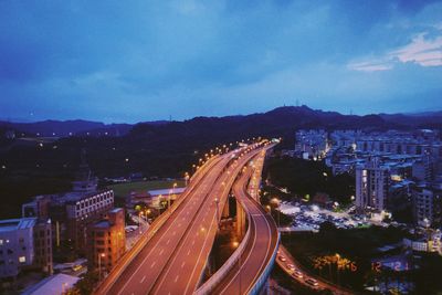 High angle view of illuminated cityscape against sky