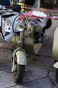 Close-up of motor scooter on street