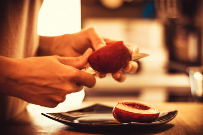 Close-up of hand holding ice cream in plate