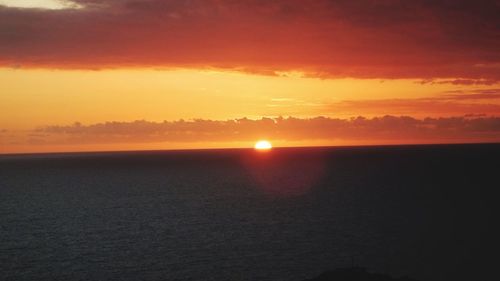 Scenic view of sea against romantic sky at sunset