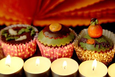 Close-up of illuminated candles on table