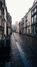 Street amidst residential buildings against sky