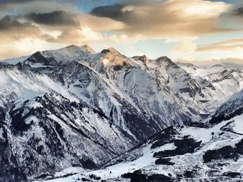 Scenic view of mountains against cloudy sky