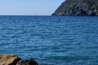 Scenic view of sea against blue sky