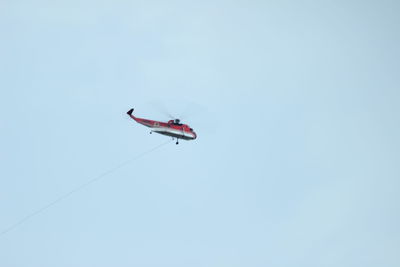 Low angle view of airplane flying against clear sky