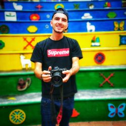 Portrait of young man photographing