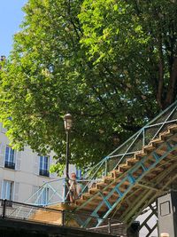 Low angle view of trees and building against sky