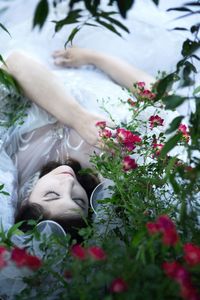 High angle view of woman lying by plants