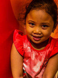 Portrait of cute girl smiling on sofa