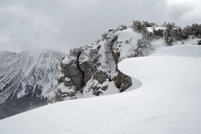 Scenic view of mountains against cloudy sky