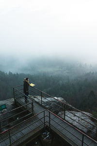High angle view of man standing on railing