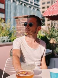 Young man with sunglasses on table