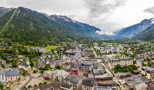 High angle view of townscape and mountains against sky